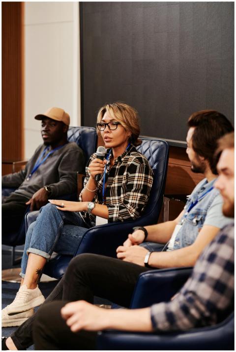 A diverse group of adults engaged in a panel discu