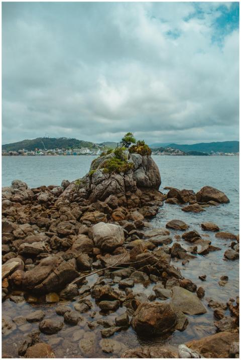 Scenic rocky seashore in Bombinhas, Brazil with cl