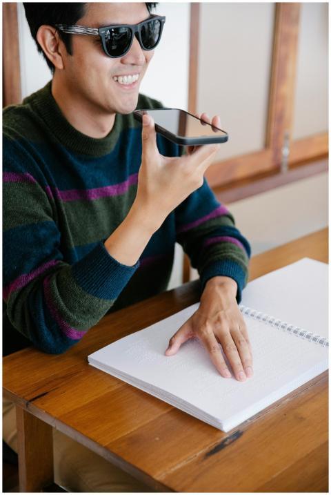 Smiling man uses smartphone for communication whil