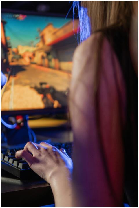 Adult woman focused on playing video game using a