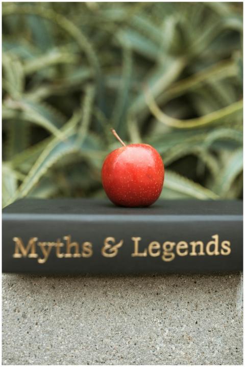 Red apple placed atop a 'Myths & Legends' book aga
