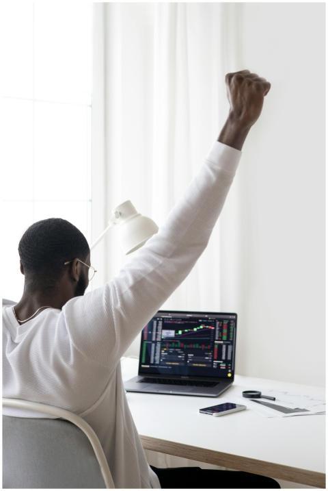 A man celebrates a successful stock market trade w