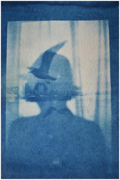 Artistic cyanotype of a woman's silhouette overlai