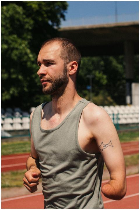 Amputee athlete running on a sunny day, epitomizin