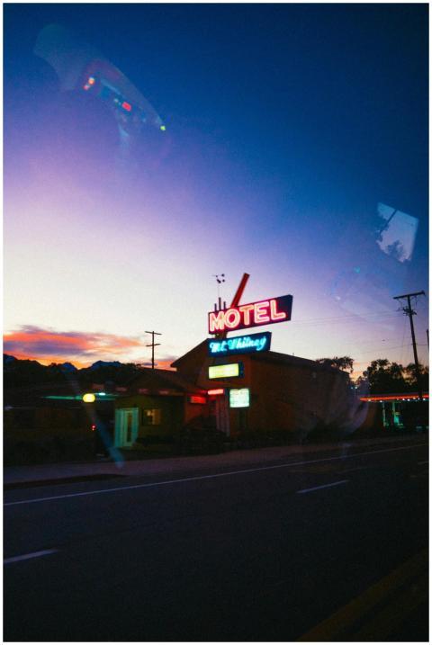 A classic neon sign lights up a roadside motel at