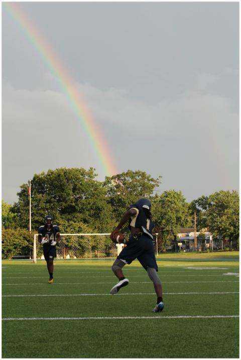 Two football players practicing on a field beneath