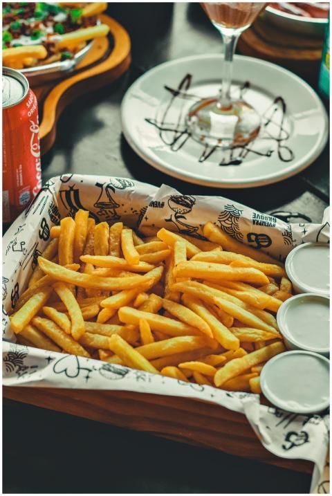 Golden French fries served with sauces and drinks