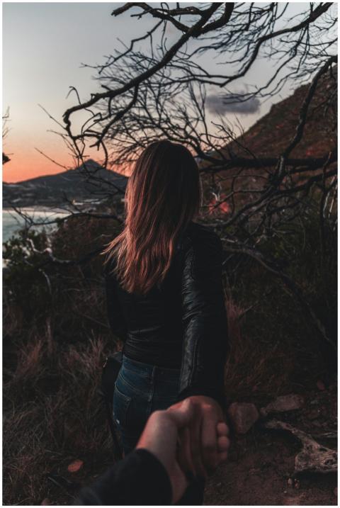 A couple holds hands walking through Cape Town's s