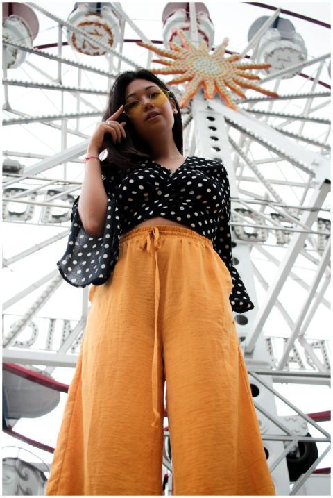 Stylish woman in polka dot blouse and sunglasses p