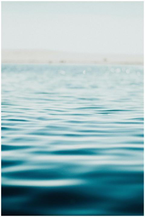 Serene ocean surface captured in soft focus, evoki