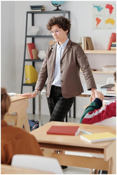 A teacher interacts with students in a modern clas