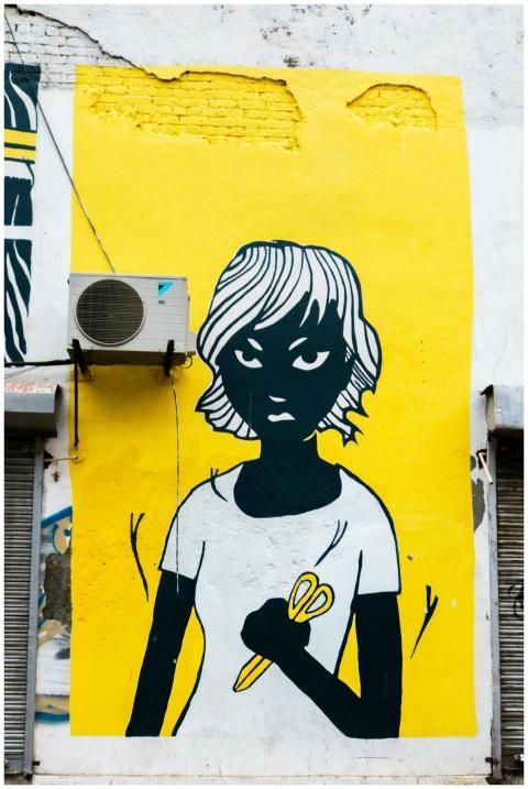 Colorful street art mural depicting a figure with