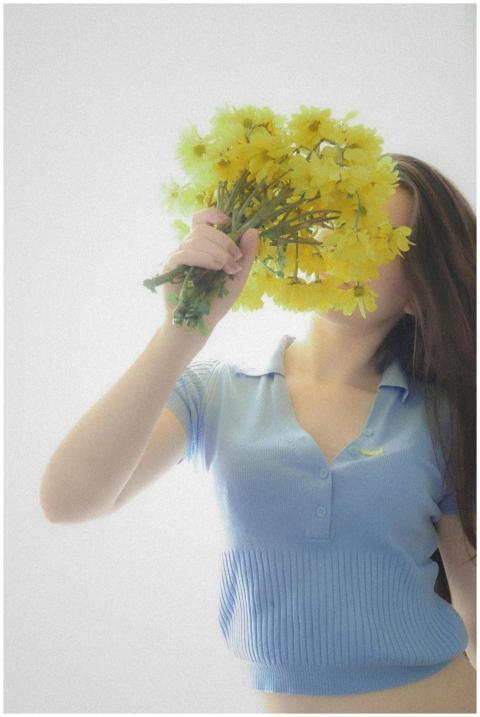 An artistic portrait of a woman holding a bouquet