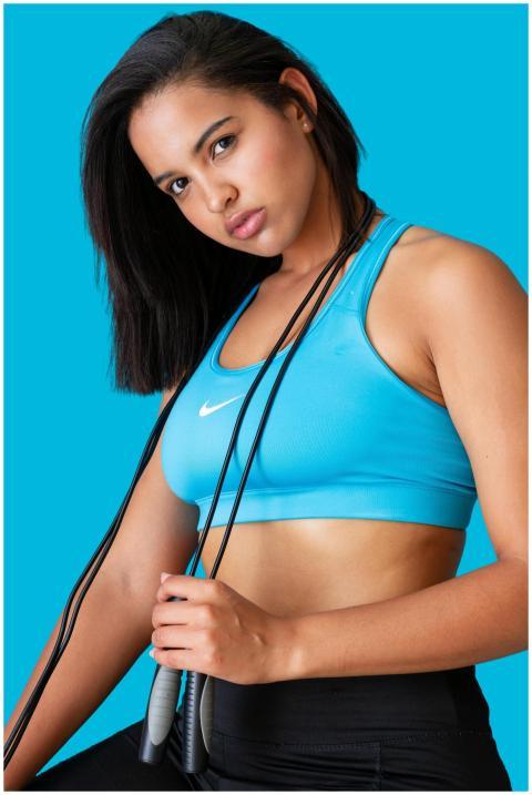 Portrait of a young woman holding a jump rope, sho