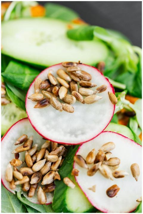 Close-up of a fresh salad with radish, seeds, and