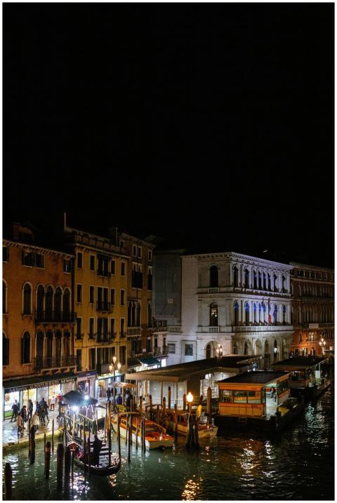Illuminated Venetian architecture and canal with g