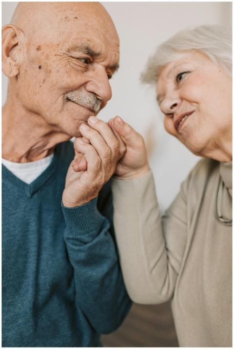 An elderly couple expressing love and affection, h