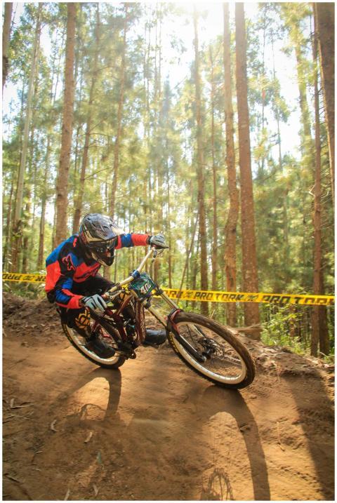 Dynamic shot of a mountain biker taking a sharp tu
