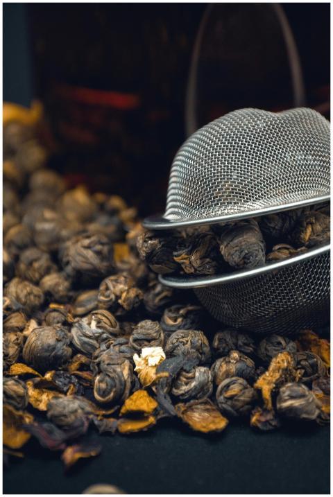 A detailed view of tea leaves and a strainer, high