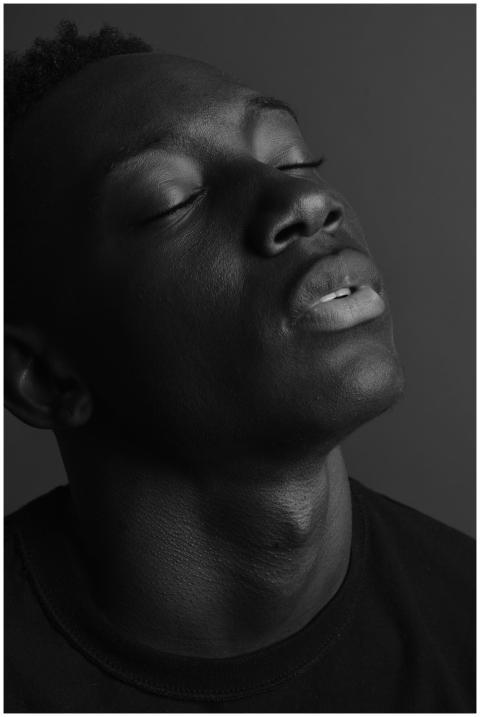 Emotive black and white portrait of a young man, e