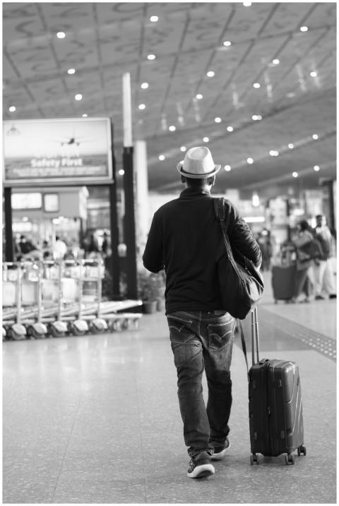 Back view of a traveler with suitcase in Kolkata a