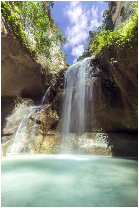 A tranquil waterfall cascading into a serene pool