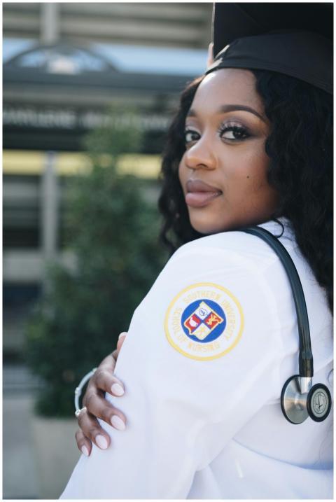 Confident nursing graduate posing outdoors in Bato