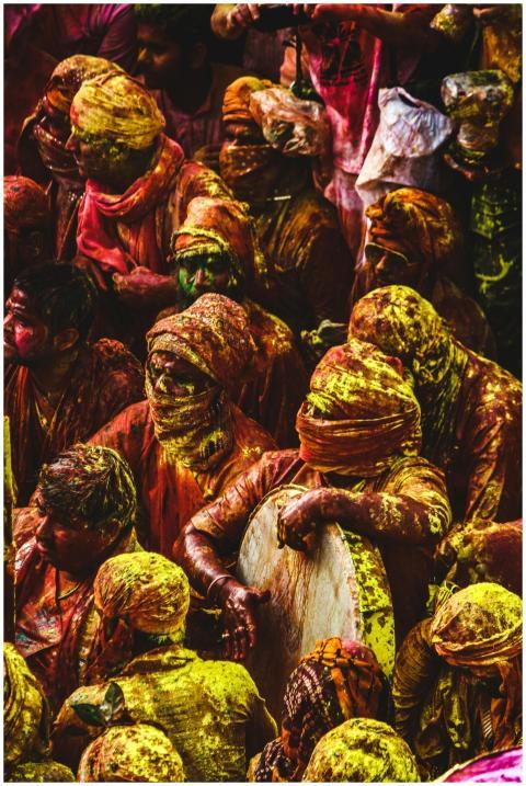 Colorful crowd celebrating Holi festival with vibr