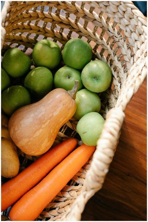 A wicker basket filled with fresh vegetables and f