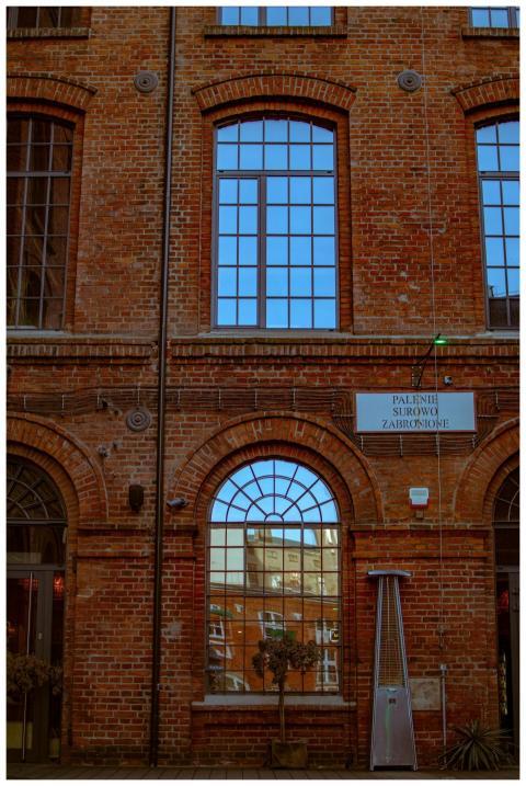 Classic brick factory facade with windows reflecti