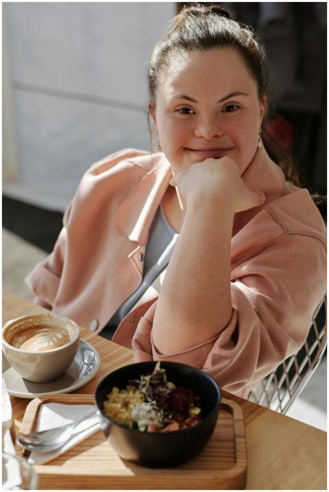 Smiling young woman with down syndrome enjoying br