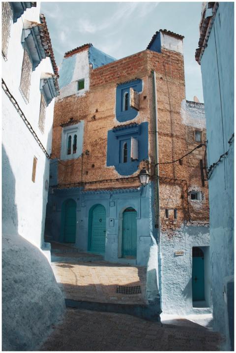 Discover the vibrant blue facades and narrow alley