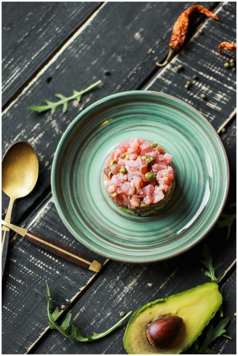 Fresh salmon tartare with avocado on elegant plate