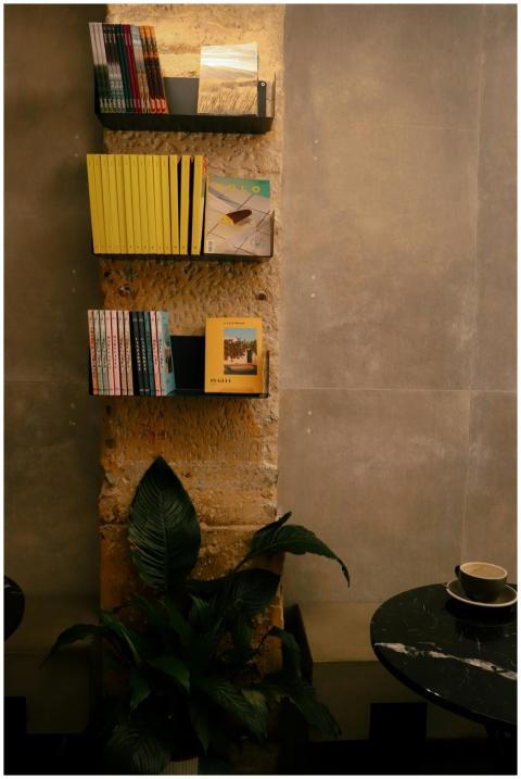 Warm and inviting book shelf setup in a Paris café