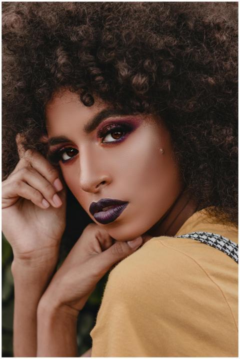 Close-up portrait of a woman showcasing bold makeu