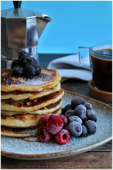 Stack of pancakes with berries and coffee, perfect