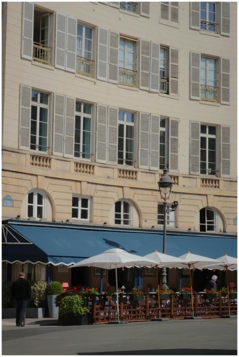 A classic Parisian building with a charming outdoo