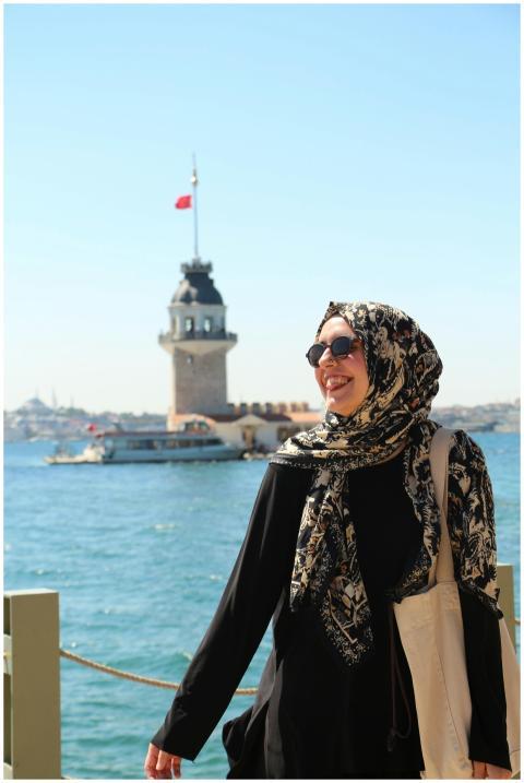 Happy woman in hijab near Maiden's Tower, Istanbul