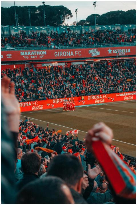 Excited fans cheer as Girona FC celebrates a goal