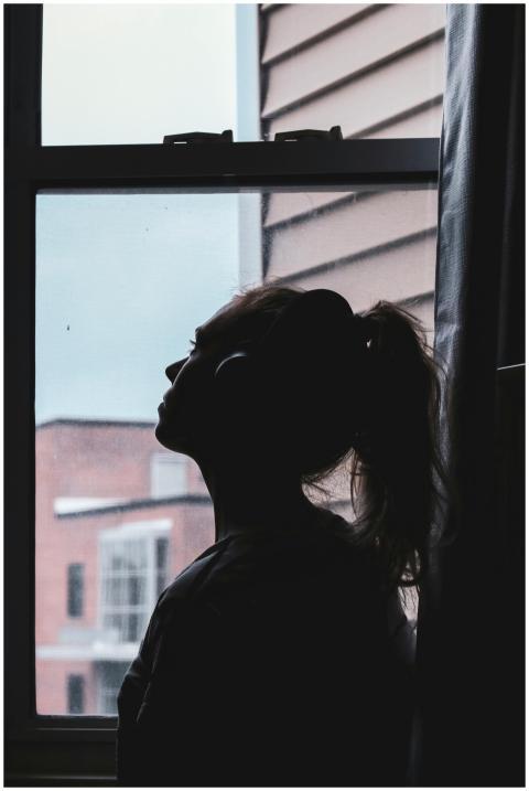 A silhouette of a woman wearing headphones, deep i