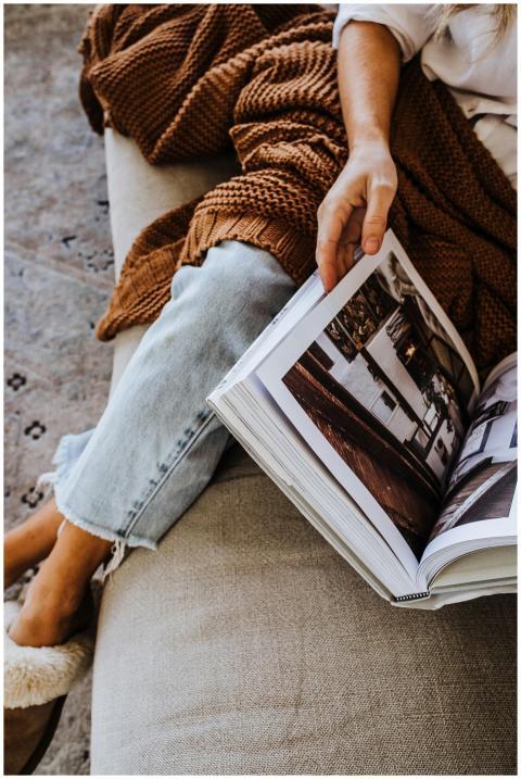 From above of crop anonymous female in jeans sitti