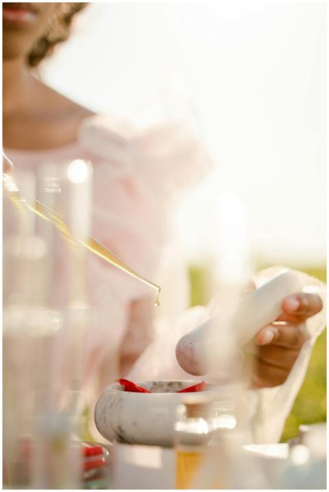 Close-up of pipette dripping liquid into a mortar