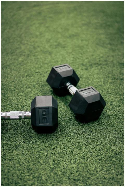 Two 30 lb hex dumbbells resting on vibrant green t