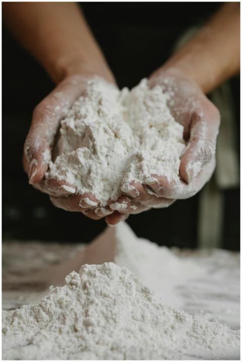 Close-up of a person holding a mound of flour in t