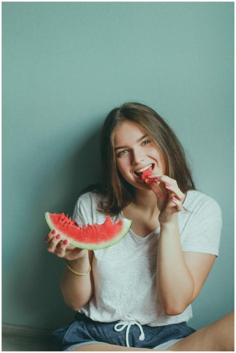 Smiling young woman sitting indoors enjoying a fre