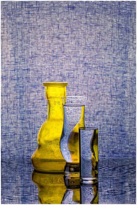 Artistic display of glass bottles reflecting again