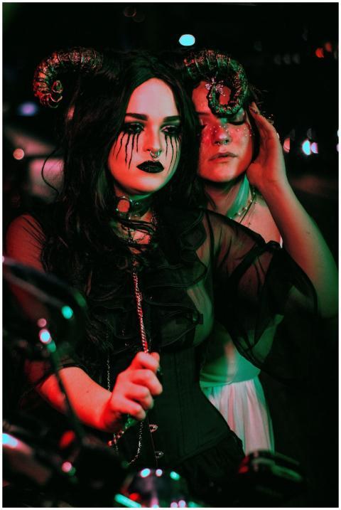 Two women in fantasy costumes at a Halloween party