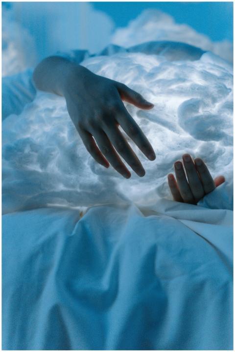 Dreamlike scene of hands embracing an ethereal clo