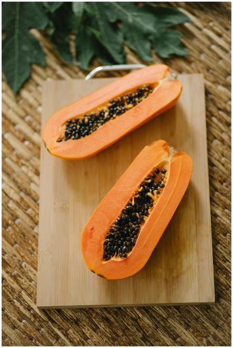 From above of fresh tasty juicy papaya with seeds