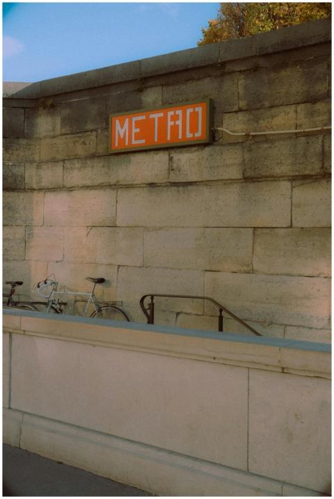 Vintage Paris metro entrance with bicycle against